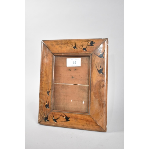 39 - An Italian Sorrento Olive wood Photo Frame Decorated with Swallows, 23x19cms