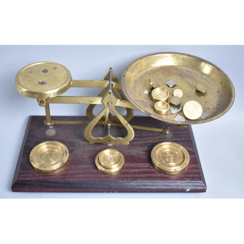 44 - A Set of Brass Postage Scales Set of Wooden Plinth together with Mixed Metric Weights, 20.5cms Wide