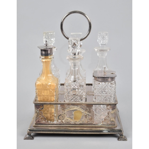 51 - A Late Victorian/Edwardian Six Bottle Cruet having Silver plated Rectangular Stand and Ring Handle, ... 