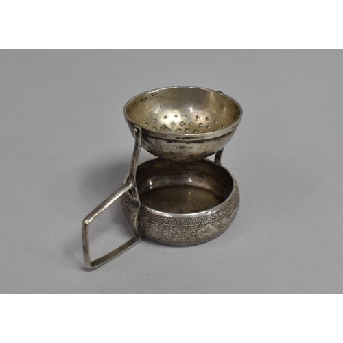 9 - A Far Eastern White Metal Gimballed Tea Strainer with Circular Tray, 6cms High