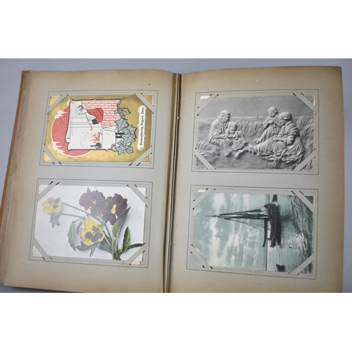 104 - An Early 20th Century Postcard Album Containing Coloured and Monochrome Scenic Postcards