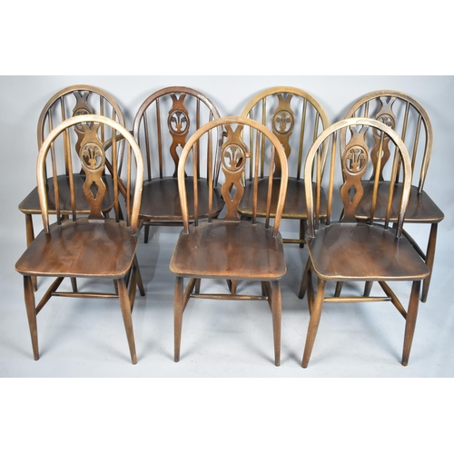 489 - A Set of Seven Ercol Hoop Back Fleur De Lys Chairs to Include One Carver