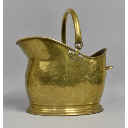 71 - A Mid 20th Century Hammered Brass Helmet Shaped Coal Scuttle, 39cms High Overall