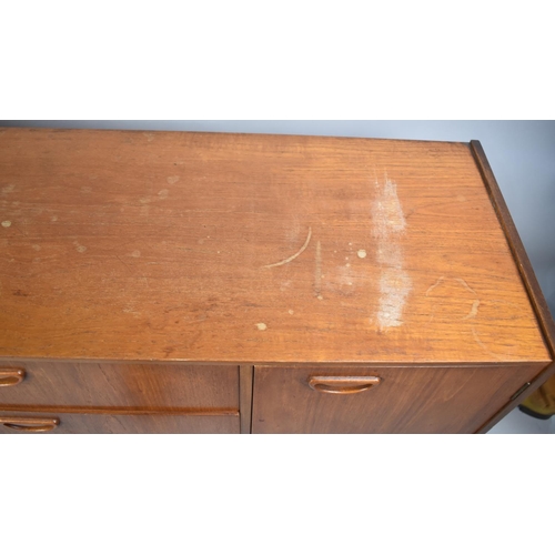 494 - A 1970's Teak Sideboard with Three Centre Drawers Flanked by Cupboards, 138cm wide, Damaged Top