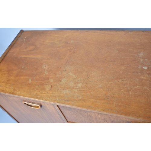 494 - A 1970's Teak Sideboard with Three Centre Drawers Flanked by Cupboards, 138cm wide, Damaged Top