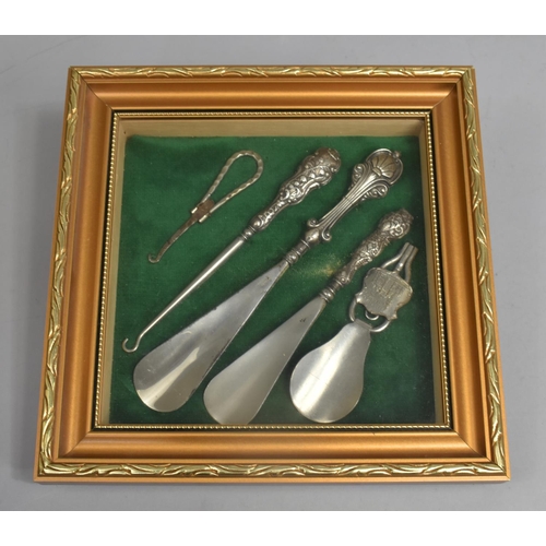 39 - A Framed Collection of Silver Mounted and Silver Plated Shoe Horns and Button Hooks, 25.5cms Square