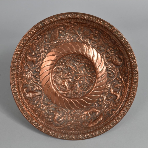 41 - A Beaten Copper Bowl Decorated with Birds and Animals, 24cms Diameter