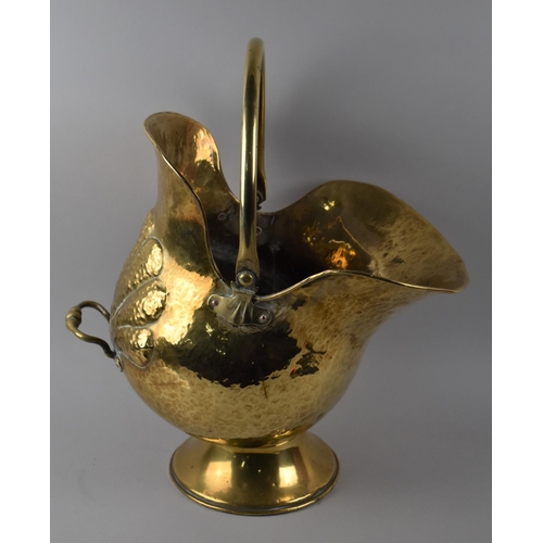 63 - A Pressed Brass Helmet Shaped Coal Scuttle with Loop Handle, 50cms High