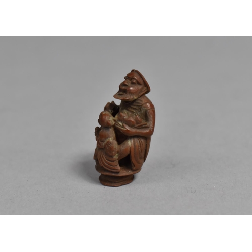 244 - A 19th Century Chinese Carved Hediao Nut in the Form of an Eldar and Attendant, 4cms High