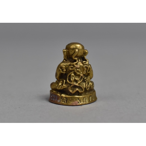 245 - A Small Bronze Travel Icon, Study of Buddha in Seated Position with Hands on Eyes, 2cms High