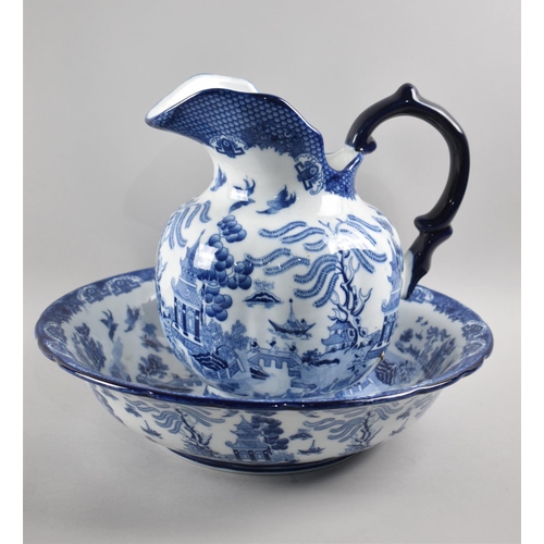 372 - A Blue and White Transfer Printed Willow Pattern Toilet Jug and Bowl