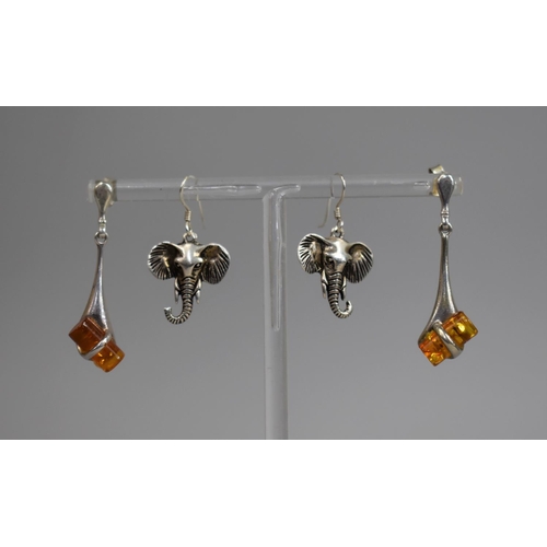 465 - A Pair of Silver Earrings in the Form of Elephant Heads together with a Pair of Silver and Amber Dro... 