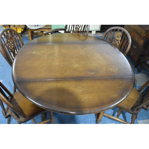 541 - An Ercol Type Dark Oak Refectory Style Drop Leaf Dining Table with a Set of Six Matching Wheelback C... 