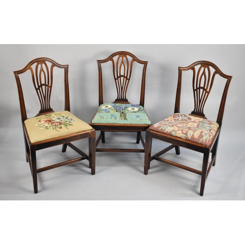 552 - A Set of Three Mahogany Framed Dining Chairs with Tapestry Seats, Tapering Square Supports Joined by... 