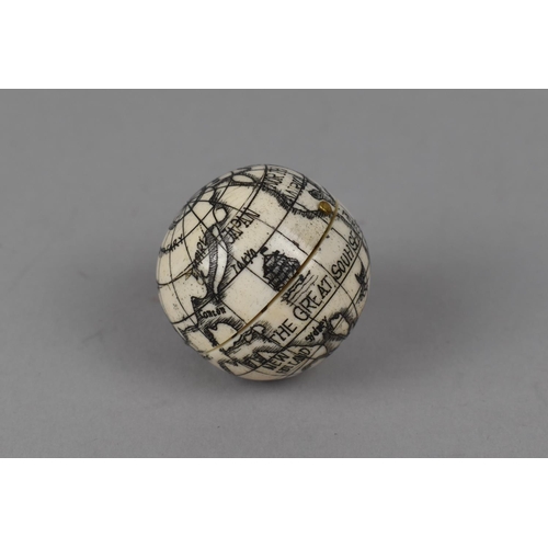 121 - A Reproduction Small Bone Scrimshaw Style Compass in the form of a Hinged Globe, 3.5cm Diameter