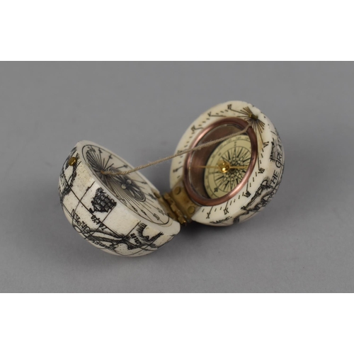 121 - A Reproduction Small Bone Scrimshaw Style Compass in the form of a Hinged Globe, 3.5cm Diameter