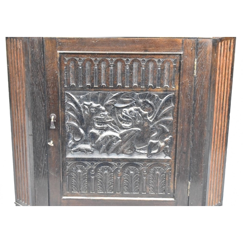 519 - A 19th Century Carved Oak Corner Cabinet with Carved Door Decorated with Welsh Dragons, 78cm wide an... 