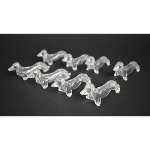 224 - A Collection of Eight Clear Plastic Knife Stands in the Form of Dachshunds