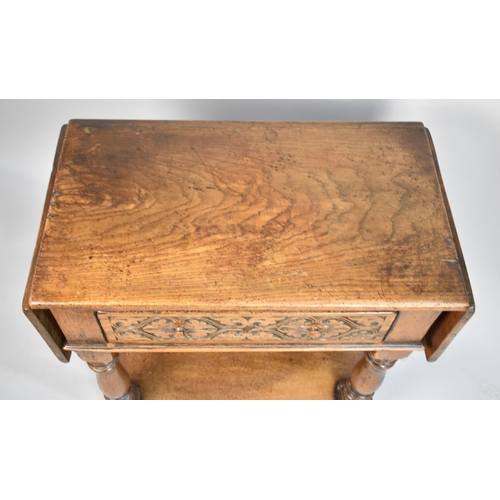 26 - A Mid 20th Century Oak Drop Leaf Side Table with Single Carved Drawer, Turned Supports and Pot Board... 