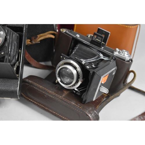 383 - A Collection of Various Vintage Cameras to comprise Zeiss Ikon Bellows Camera together with a pair o... 