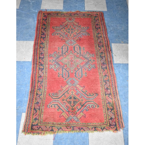 559 - A Small Patterned Rug on Red Ground, 161x89cm