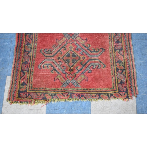 559 - A Small Patterned Rug on Red Ground, 161x89cm