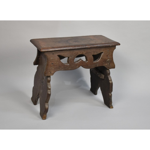 76 - An Early Oak Rectangular Topped Stool with Pierced Side Panels, Top 50cms by 23cms