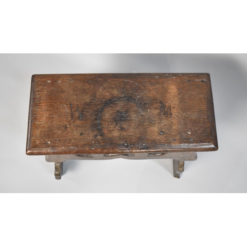 76 - An Early Oak Rectangular Topped Stool with Pierced Side Panels, Top 50cms by 23cms