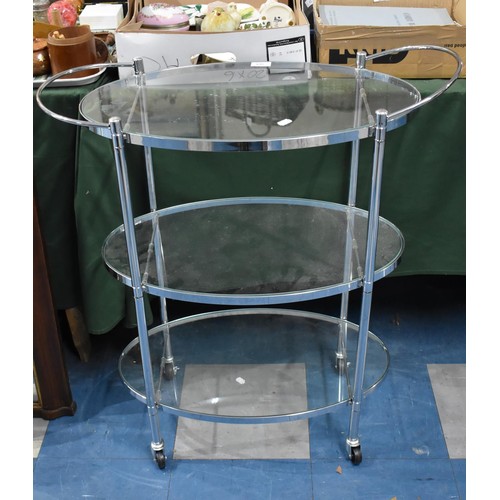 569 - A Modern Chrome and Glass Oval Three Tier Trolley, 73cm wide