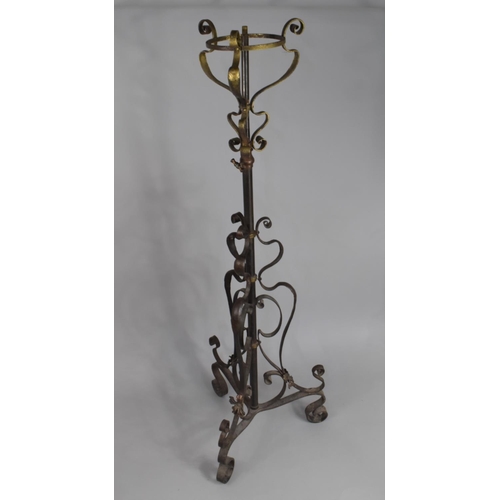 512 - A Victorian Rise and Fall Wrought Iron and Brass Oil Lamp Stand on Scrolled Tripod Support