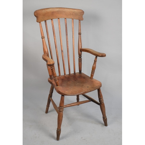 558 - An Edwardian Elm Seated Spindle Back Kitchen Arm Chair