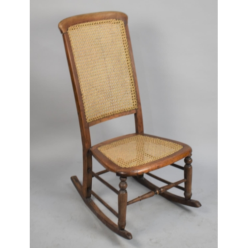 559 - An Edwardian Cane Seated and Backed Nursing Rocking Chair