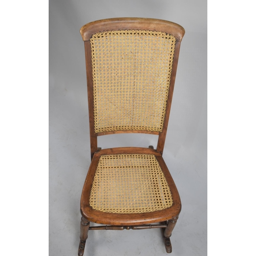 559 - An Edwardian Cane Seated and Backed Nursing Rocking Chair