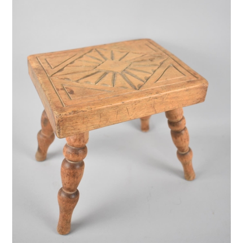 57 - A Small Carved Wooden rectangular Topped Stool with Turned Supports, 22cms Wide
