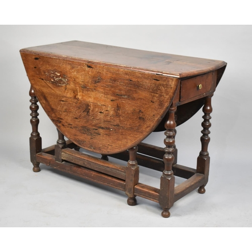 72 - A Late 19th Century Oak Oval Topped Drop Leaf Gate Leg Dining Table, 104cms Wide