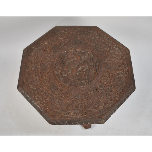 86 - An Intricately Carved Indian Octagonal Table Top Mounted on Tree Trunk Base, 68cms Diameter