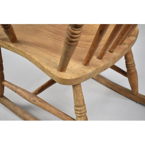 609 - An Elm Seated Spindle Back Rocking Chair