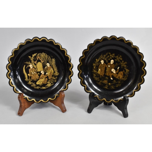 619 - A Pair of Chinese Lacquered Circular Scalloped Edged Dishes decorated with Monks Playing in Garden, ... 