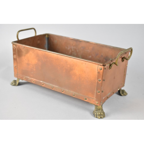 64 - A Rectangular Copper Planter with Brass Handles and Claw Feet, 28x14cms