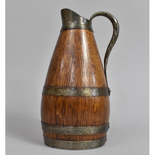 69 - An Edwardian Oak and Silver Plate Mounted Jug, 25cms High