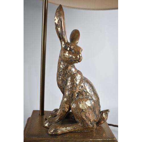 79 - A Modern gilt Decorated Metal Novelty Table Lamp in the Form of Rabbit Sat Upon Three Books, With Sh... 