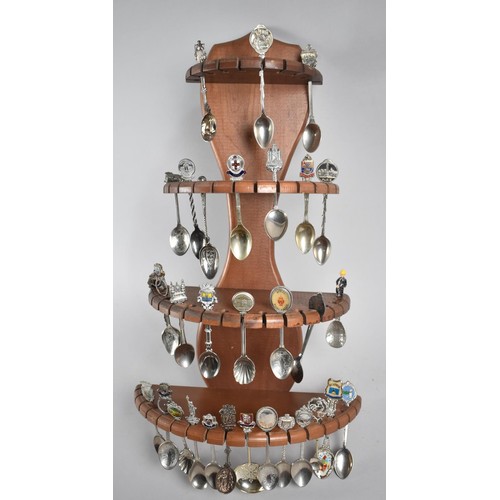 637 - A Wooden Four Tier Graduated Stand Containing Various Silver Plated Souvenir Spoons