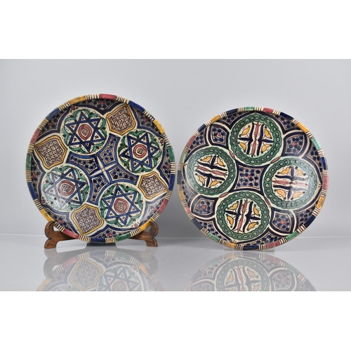 395 - Two North African Pottery Chargers decorated in Polychrome Enamels in the Islamic style with Geometr... 