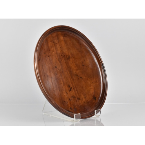 66 - A Late 18th/Early 19th Century Mahogany Circular Tray with Dished Edge, 25cms Diameter