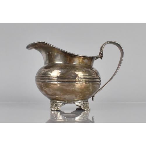 170 - A Georgian Silver Jug, London Hallmark, Although Rubbed, with Reeded Trim and Scrolled Handle, Raise... 