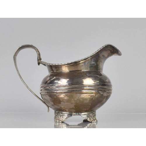 170 - A Georgian Silver Jug, London Hallmark, Although Rubbed, with Reeded Trim and Scrolled Handle, Raise... 