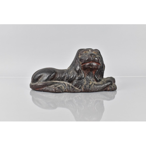 79 - An 18th/19th Century Cast Iron Doorstop in the Form of a Recumbent Lion Having Remnants of Painted D... 