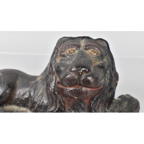 79 - An 18th/19th Century Cast Iron Doorstop in the Form of a Recumbent Lion Having Remnants of Painted D... 