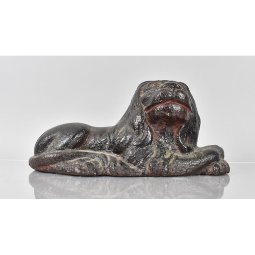 79 - An 18th/19th Century Cast Iron Doorstop in the Form of a Recumbent Lion Having Remnants of Painted D... 