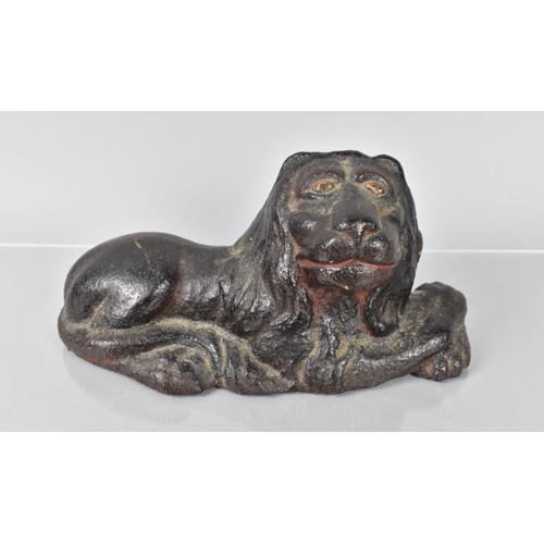 79 - An 18th/19th Century Cast Iron Doorstop in the Form of a Recumbent Lion Having Remnants of Painted D... 